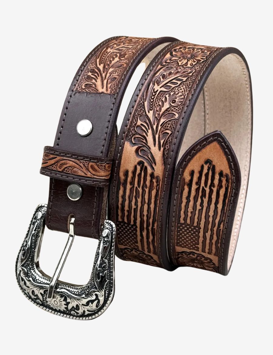 Western leather belt featuring American flag tooling, floral carvings, and an engraved silver cowboy buckle.