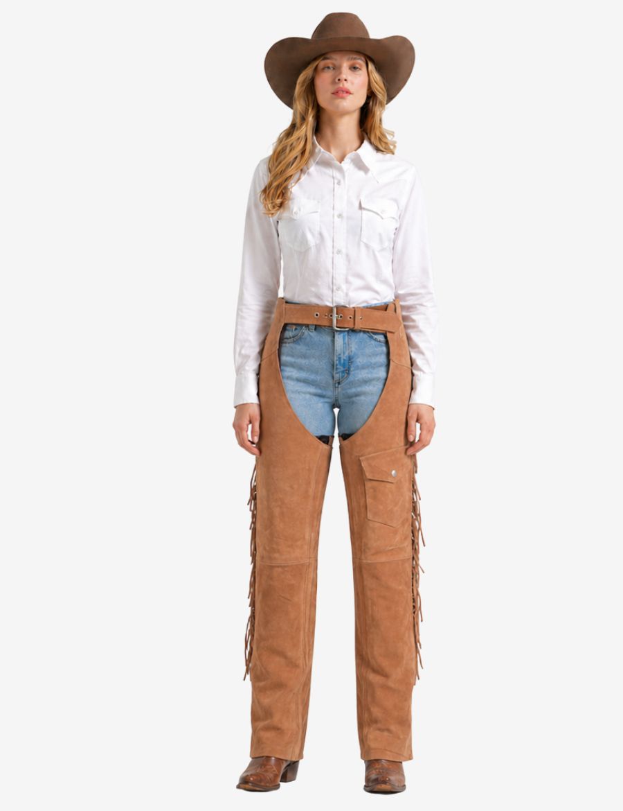 Cowgirl wearing beige womens western chaps with fringe, suede leather construction, western belt, and riding-ready design.
