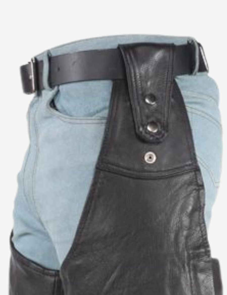 Close-up detail of removable belt on biker assless chaps featuring black leather strap and metal snap hardware.