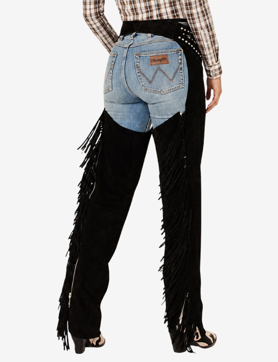 Back view of black cowgirl assless chaps with long fringe styling over blue denim jeans.