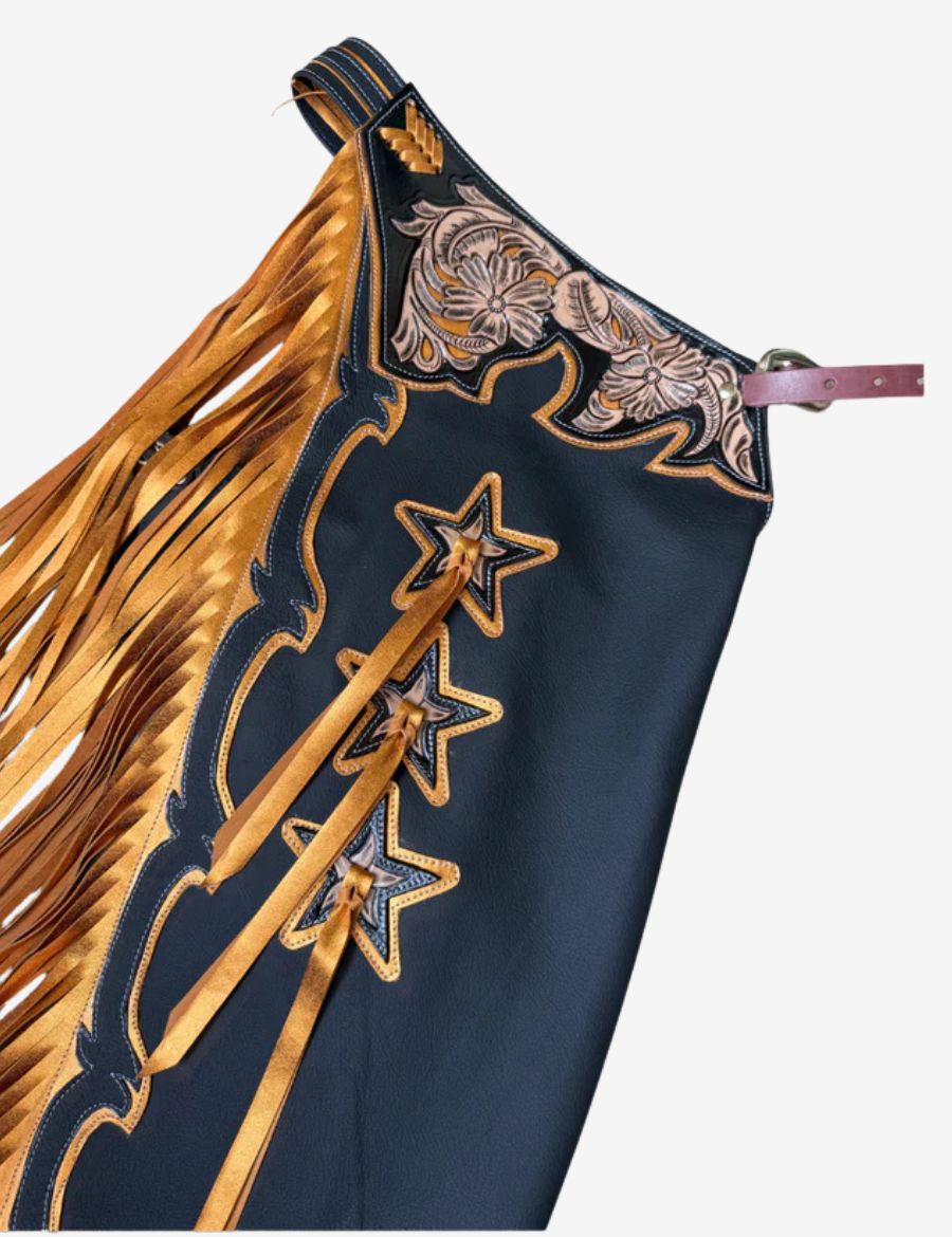 Detailed view of black rodeo chaps featuring floral tooled yoke, star accents, and premium western rodeo craftsmanship.