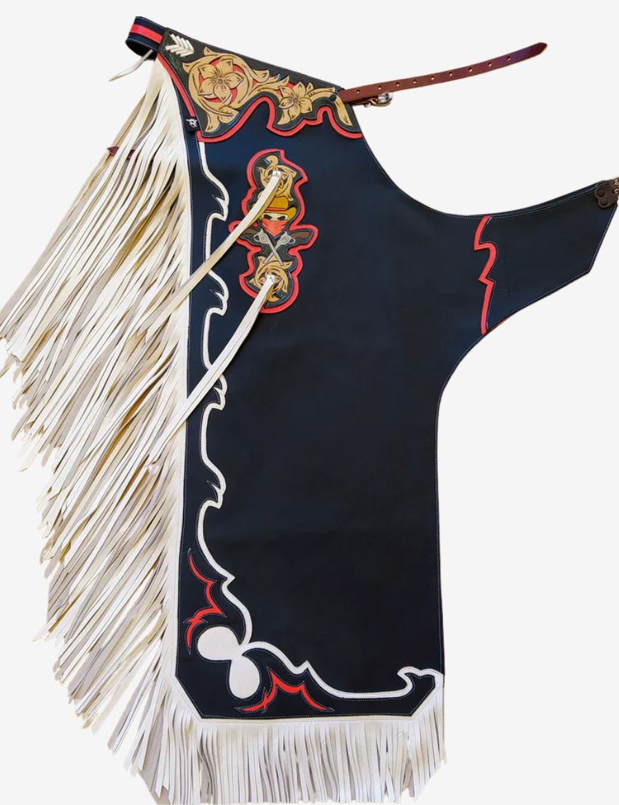 Black rodeo chaps with white fringe featuring floral tooled leather, bold rodeo accents, and premium bull riding style.