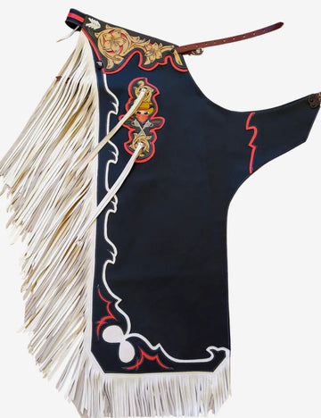 Black rodeo chaps with white fringe featuring floral tooled leather, bold rodeo accents, and premium bull riding style.