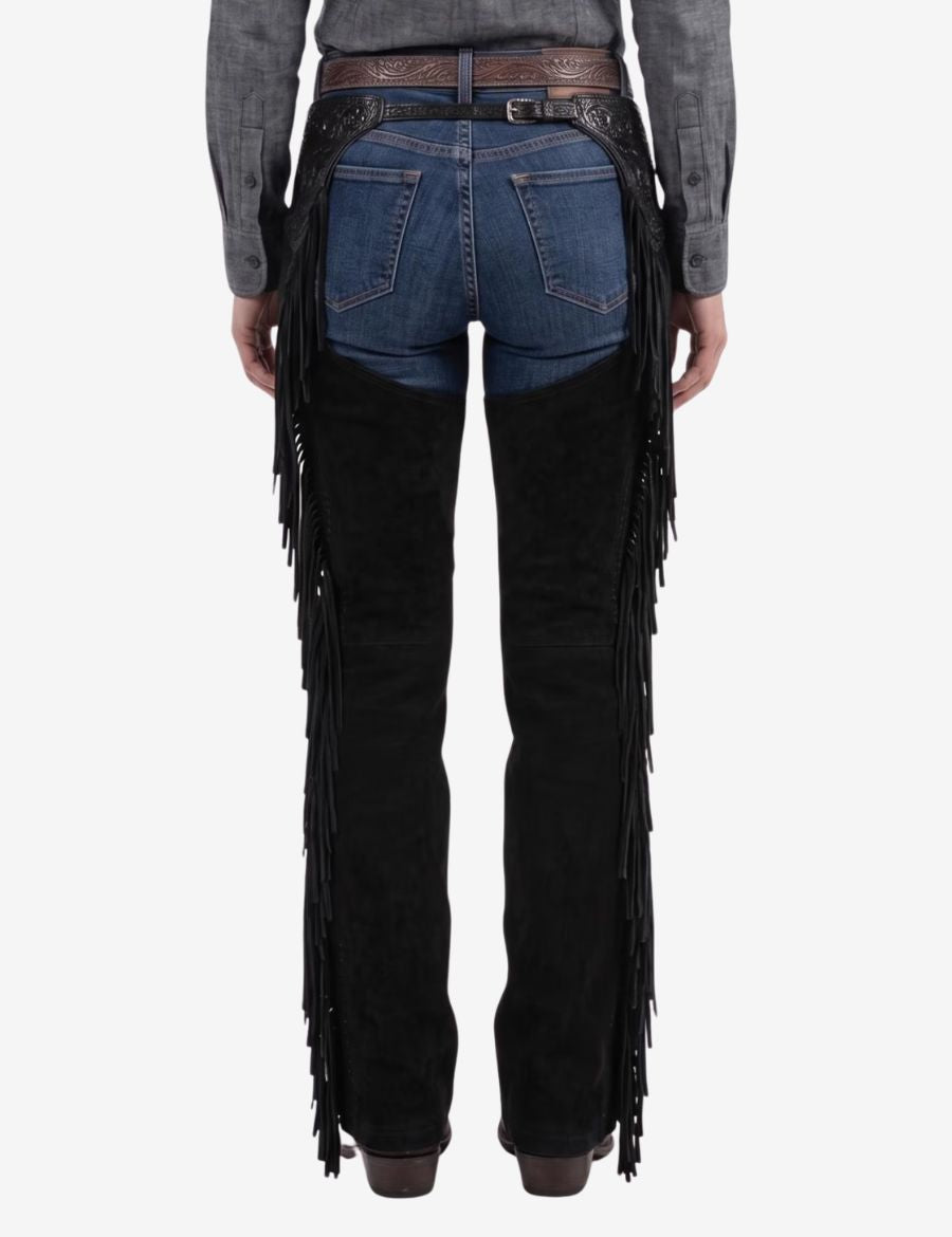 Back view of black tooled womens western chaps showcasing long fringe detailing, durable leather construction, and cowgirl-inspired design.