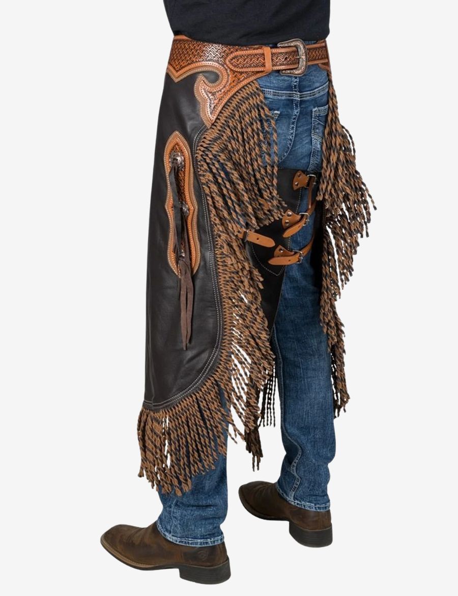 Cowboy wearing black western braided chinks chaps with braided accents, fringe detailing, and classic western ranch style.