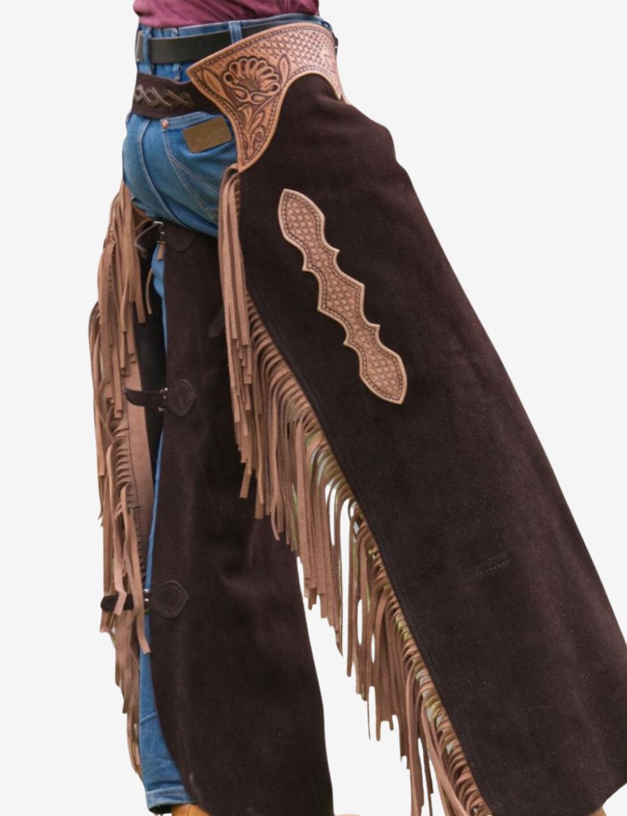 Left side angle of bronc riding cowboy chaps featuring flowing tan fringe and embossed western leather craftsmanship.