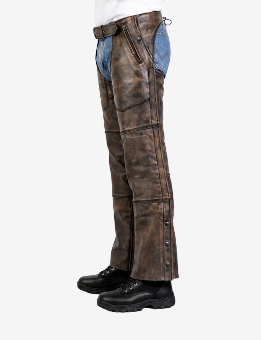 Side profile of distressed brown leather assless chaps featuring snap leg closures and zip pocket detail.