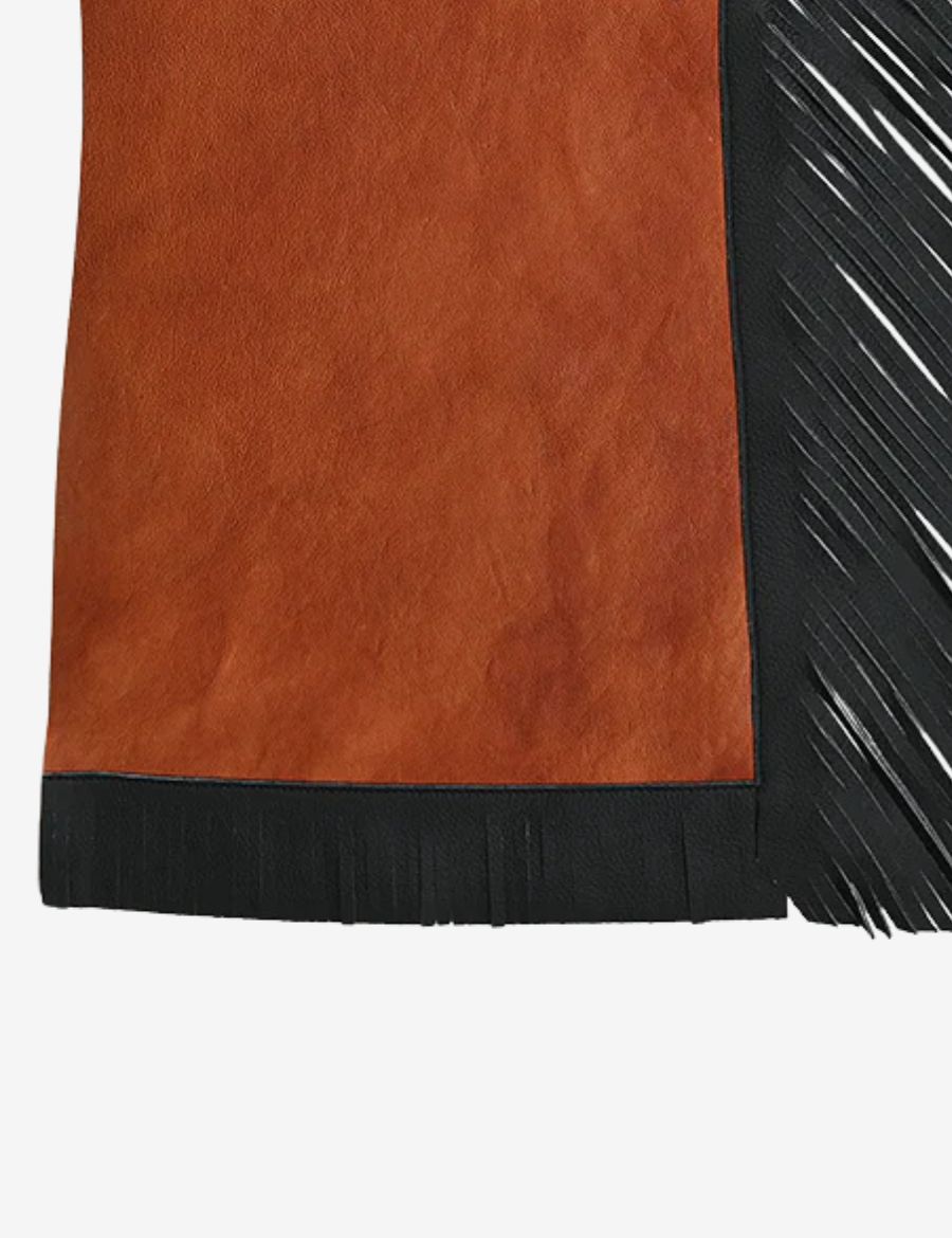 Lower leg detail of brown leather rodeo chaps with black fringe and western-style trim accents.