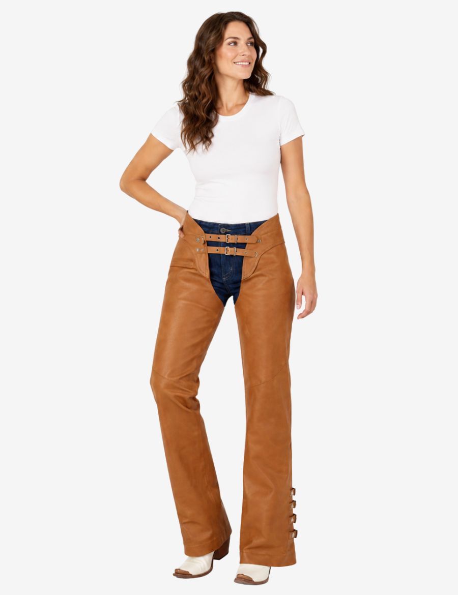 Angled front view of brown leather chaps for women with smooth leather finish and side buckle accents.