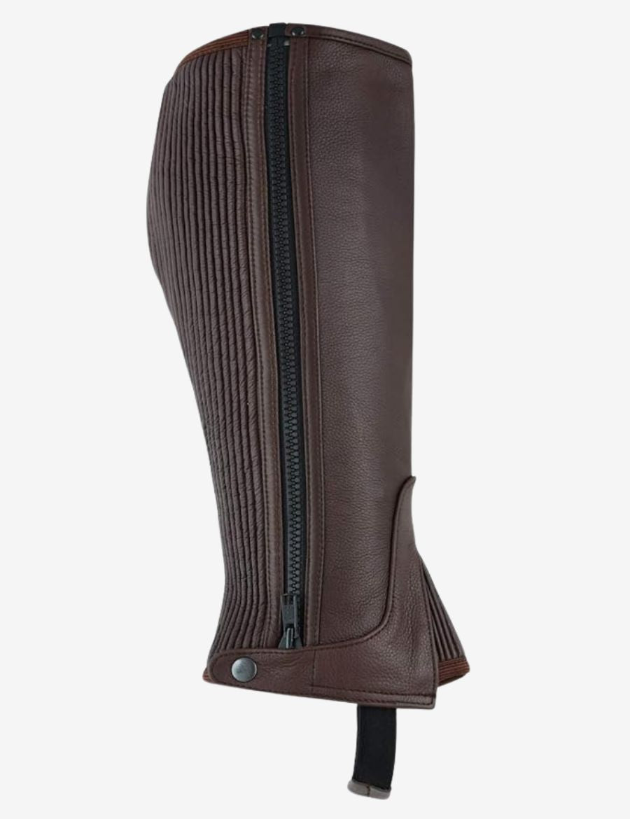 Close-up of brown leather equestrian half chaps showcasing a secure rear zipper closure, elastic stretch panel, premium leather texture, and comfortable fit