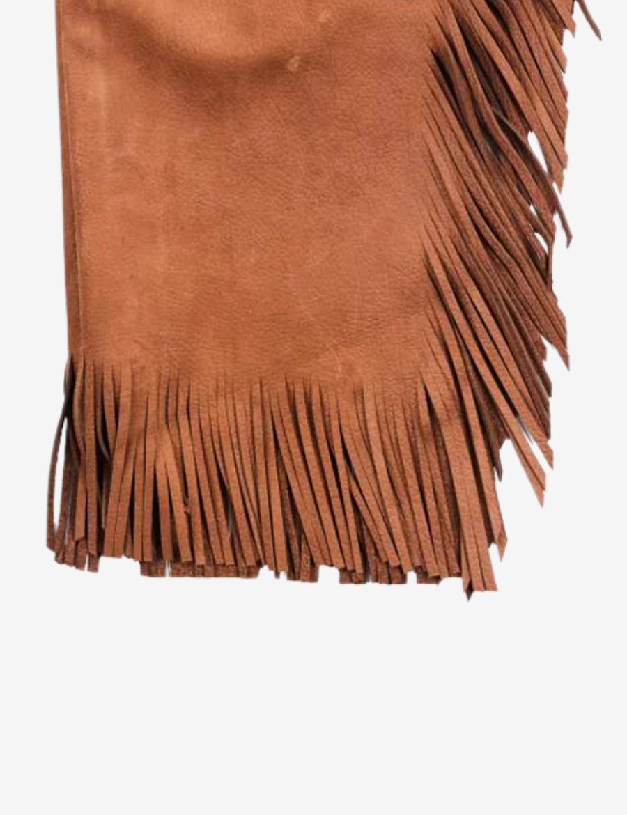 Close-up of brown suede chinks chaps highlighting stitched leather details, fringe accents, and western design.