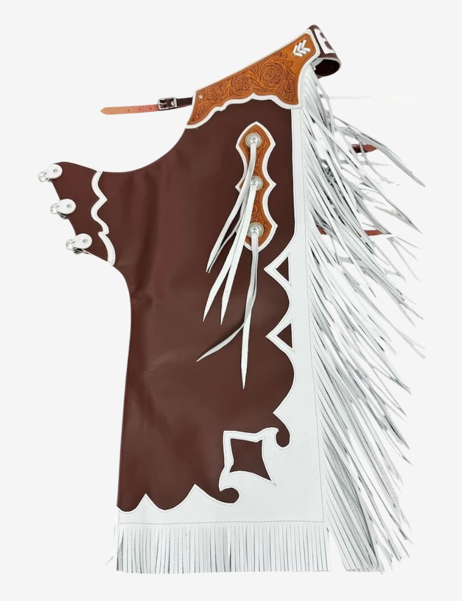 Brown and white bull riding chaps with western tooling, contrasting leather details, and long rodeo fringe.