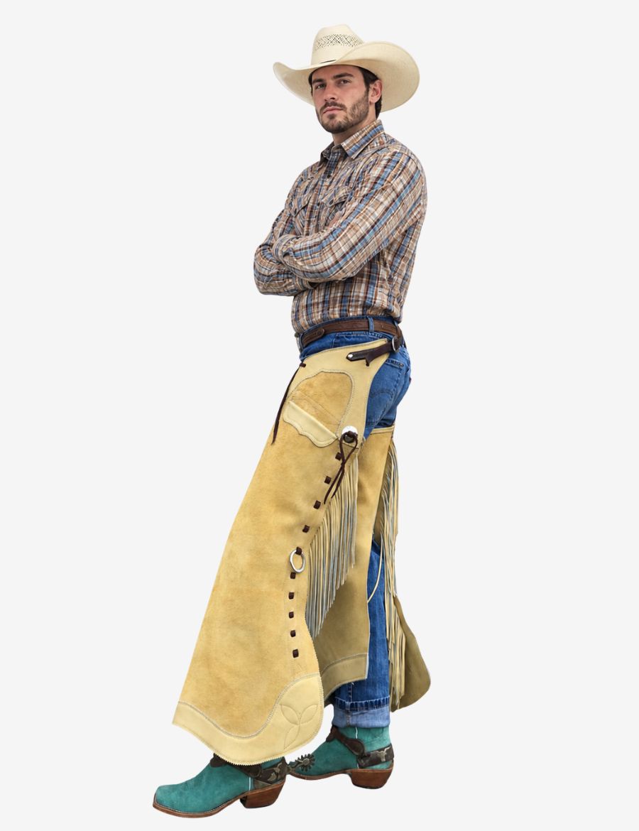 Model wearing buckaroo cowboy chink chaps with cream suede leather and classic western fringe styling.
