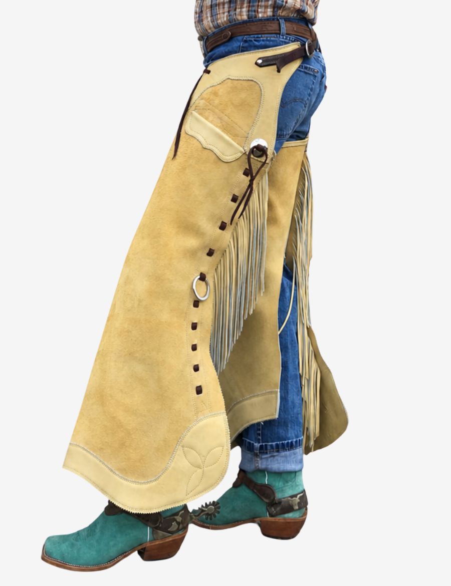 Side view of buckaroo cowboy chink chaps in cream suede with western fringe and silver ring accents.