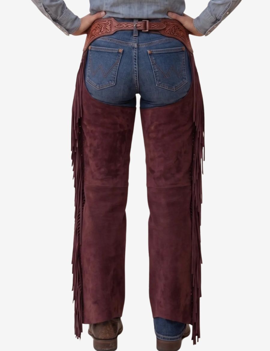 Back view of burgundy western chaps for women featuring long fringe detailing and embossed tooled leather waistband.