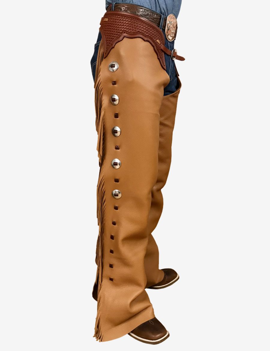 Side profile of camel brown western leather shotgun chaps with silver conchos, fringe accents, and rodeo style.