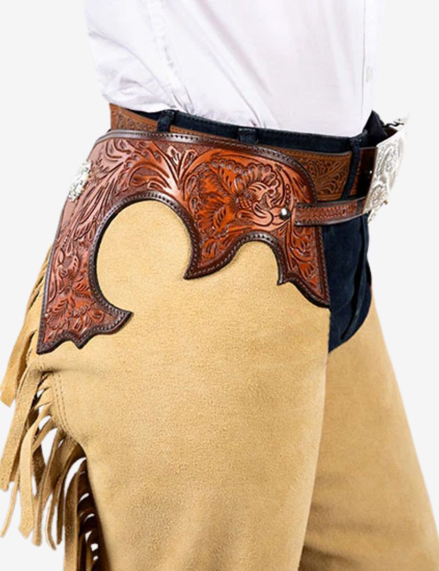 Side detail view of classic beige suede western chaps featuring floral tooled leather and western craftsmanship.