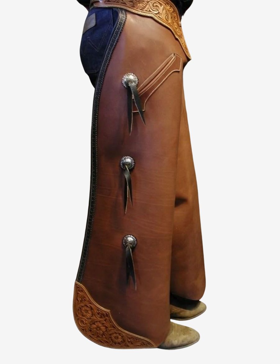Side view of classic brown leather batwing chaps with concho accents, pocket detail, and western riding style.