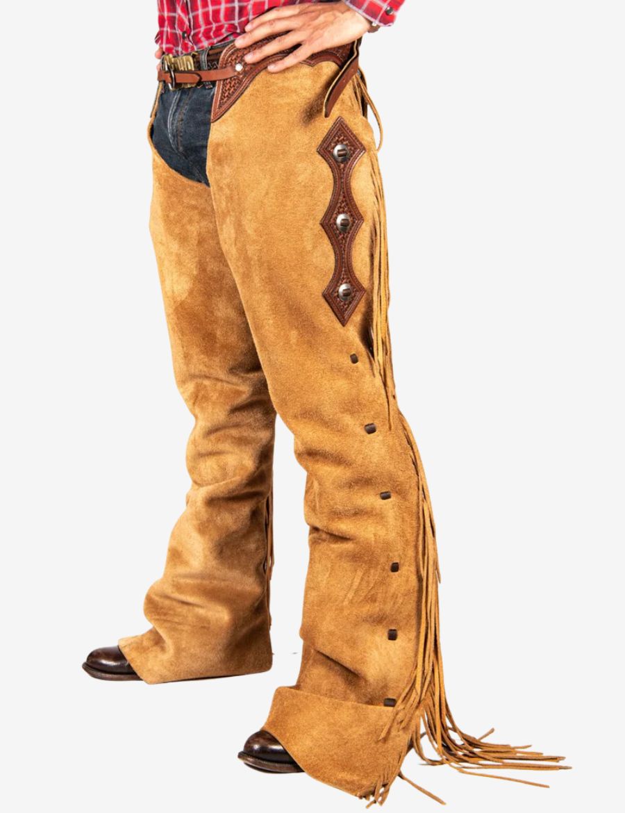 Front view of cowboy buckskin tooled show chaps in tan suede leather with western belt detailing.