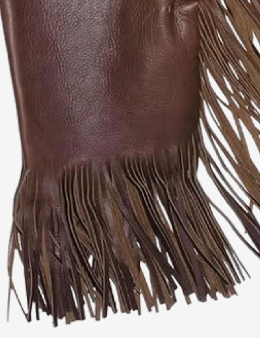 Close-up of fringe detailing on cowboy chinks chaps in oil tan leather with rugged western finish and durable leather design.