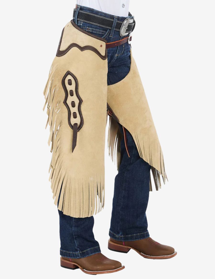 Front angled view of cowboy cream suede chinks chaps with brown trim, long fringe, and western leather detailing.