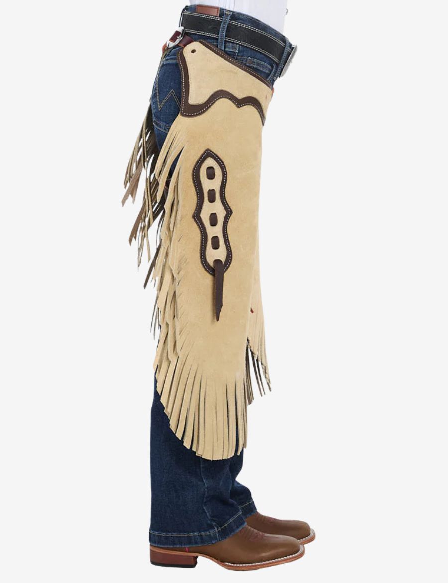 Side profile of cowboy cream suede chinks chaps featuring western fringe, contrast leather trim, and suede texture.