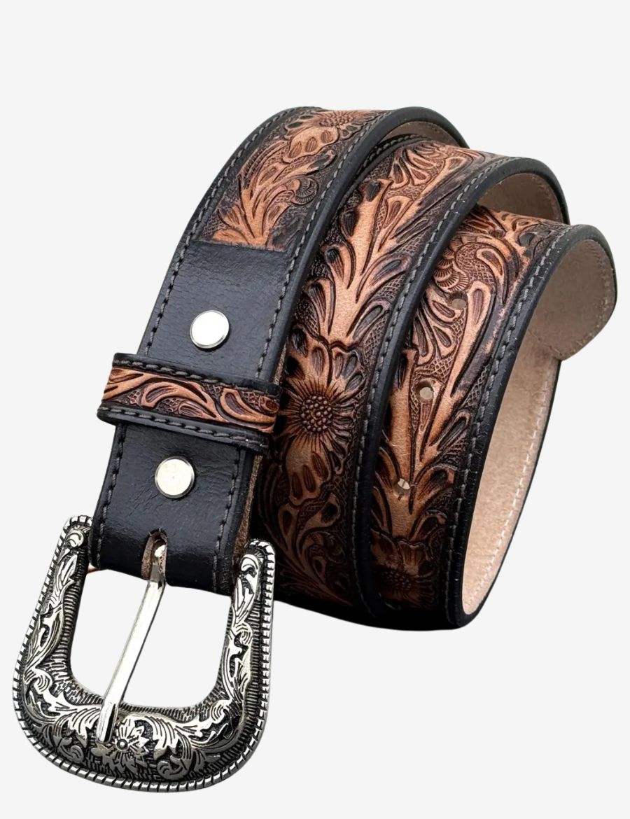 Brown leather western belt featuring hand tooled floral carvings and an engraved silver cowboy buckle.