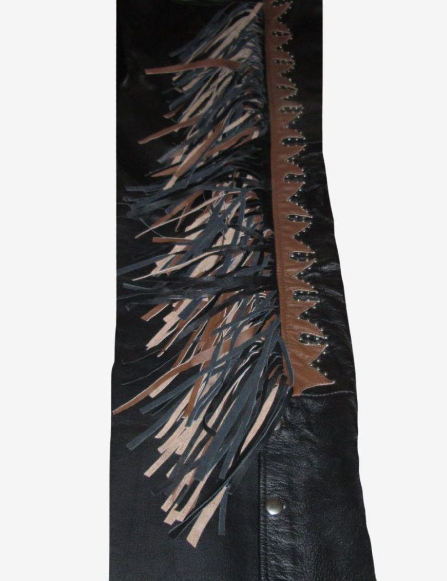Detailed close-up of black and brown leather fringe accents on cowhide western cowboy chaps.
