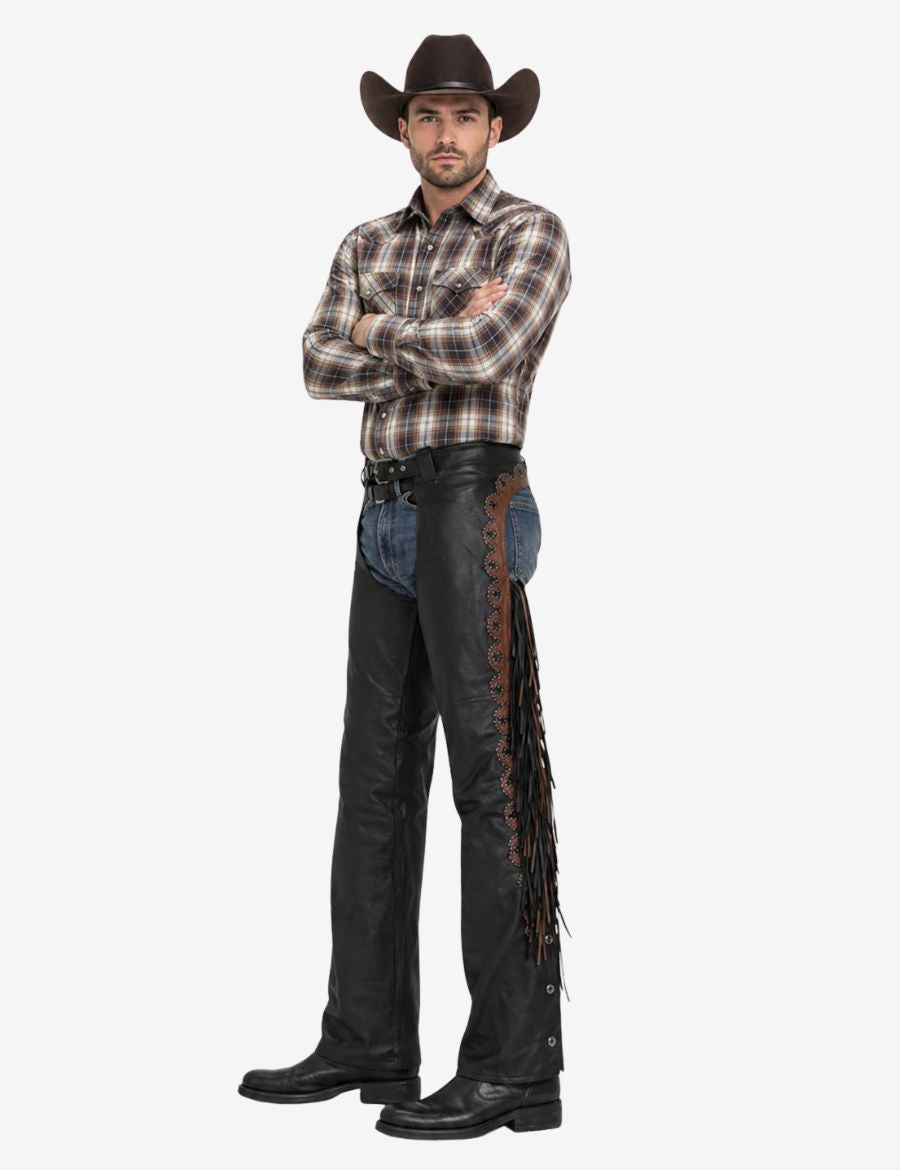 Model wearing black cowhide leather western chaps featuring brown western trim and long leather fringe.