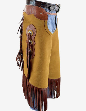 Angled front view of golden suede concho chinks chaps featuring long fringe, western trim, and detailed conchos.