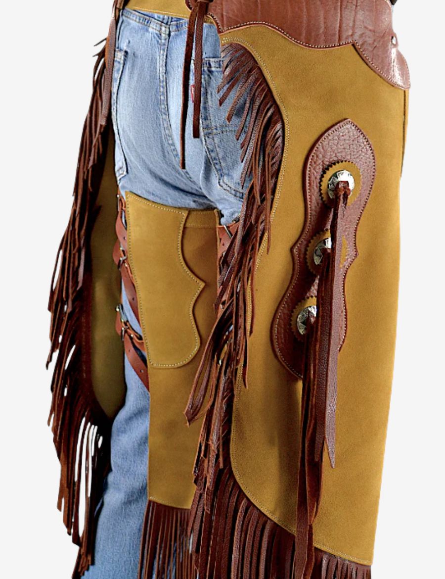 Close back detail of golden suede concho chinks chaps showing rear fringe, leather straps, and western craftsmanship.