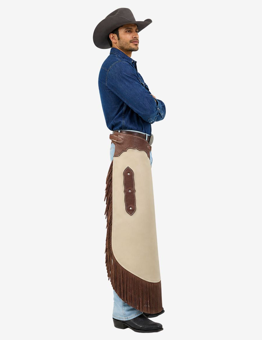 Male model wearing ivory leather cowboy chinks chaps with brown fringe, western belt, and classic rodeo styling.