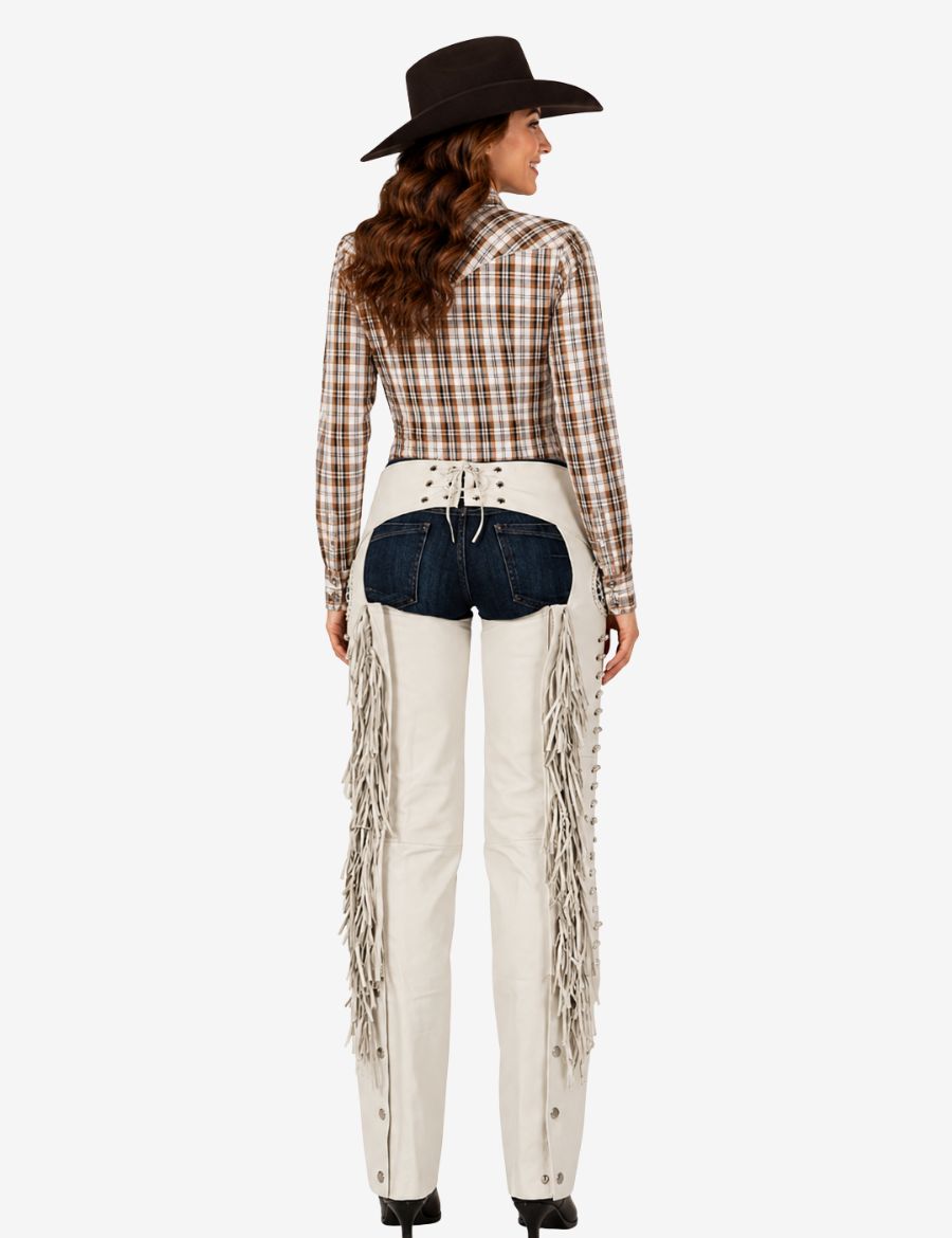Rear angled view of ivory women’s western show chaps with fringe sides, lace-up back, and classic cowgirl styling.