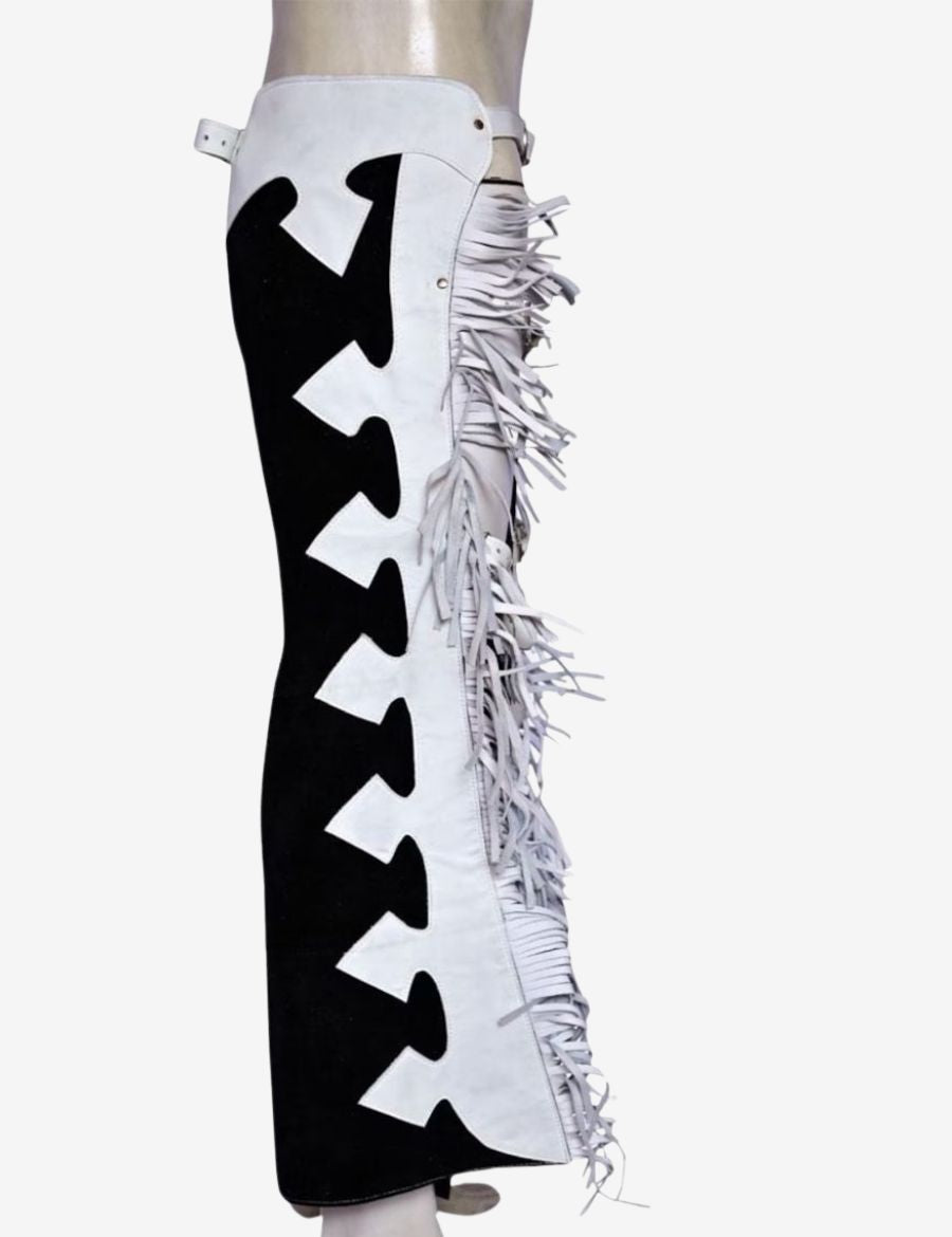 Side view of mens western black and white leather fringe chaps with layered fringe detailing.