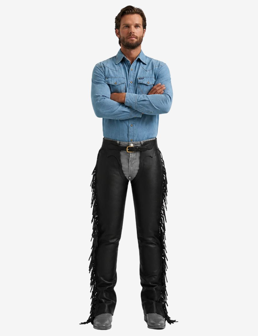 Male model wearing black leather fringe chaps in classic western rider style.