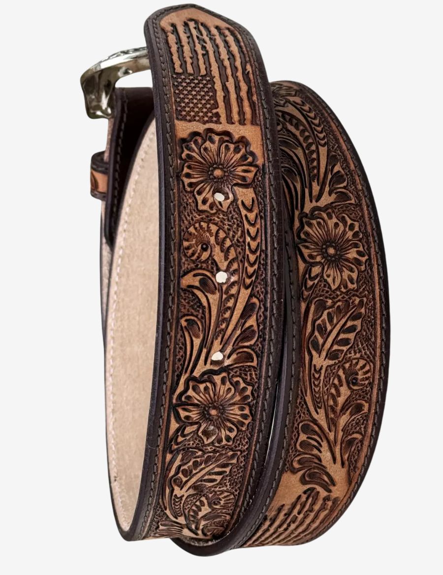 Detailed view of floral scroll tooling and American flag accents on a handcrafted western leather belt.