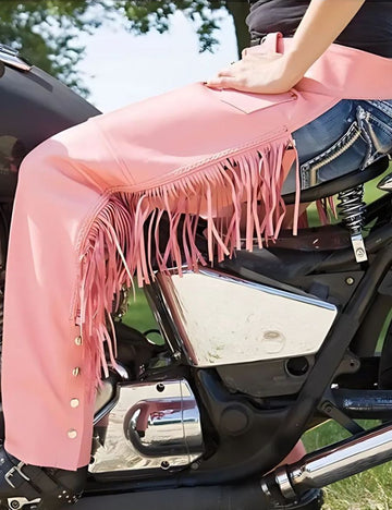 Pink motorcycle chaps with fringe crafted from leather featuring long western fringe and a bold women's riding style.
