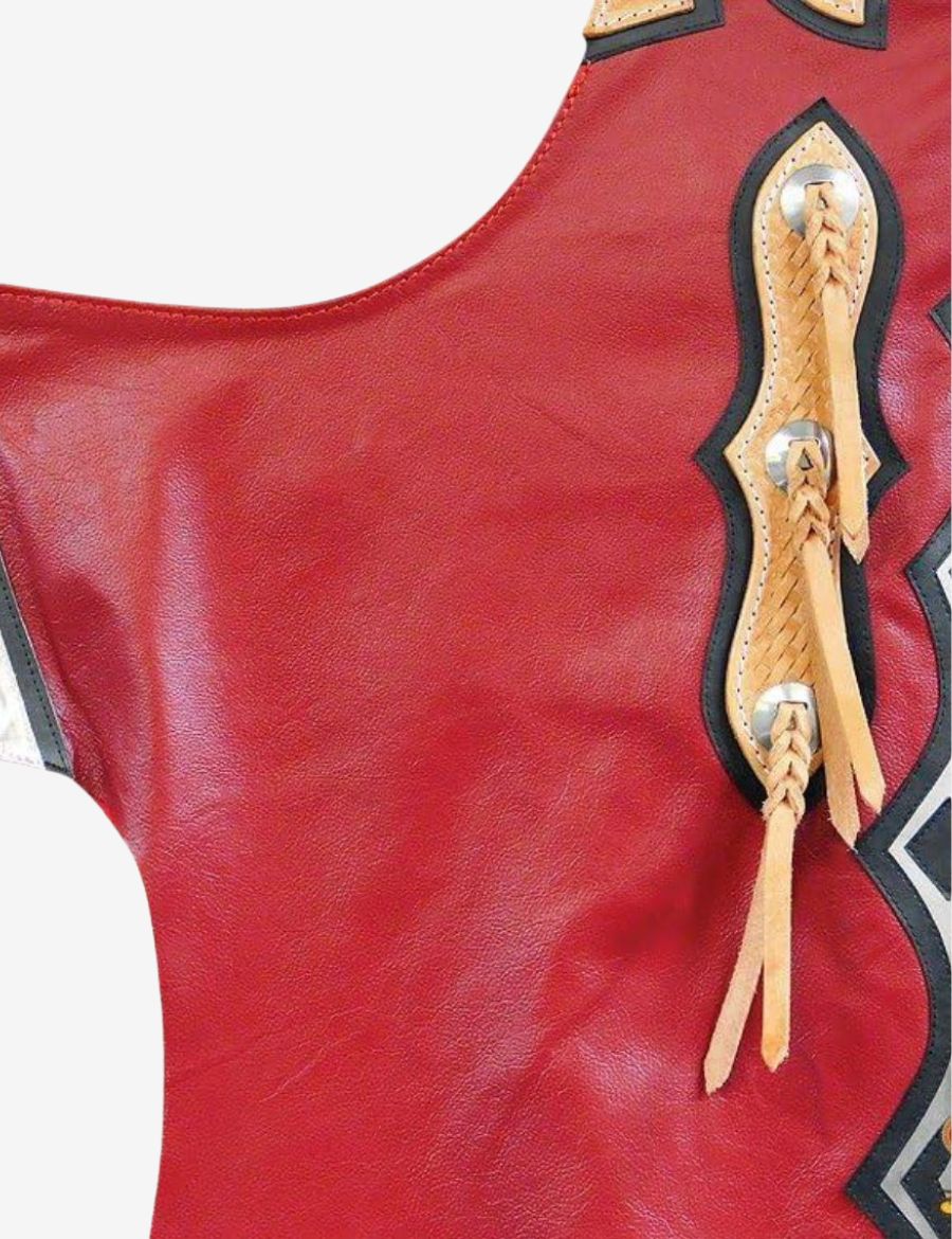 Detailed view of red leather bull riding chaps featuring braided leather conchos and western overlay accents.