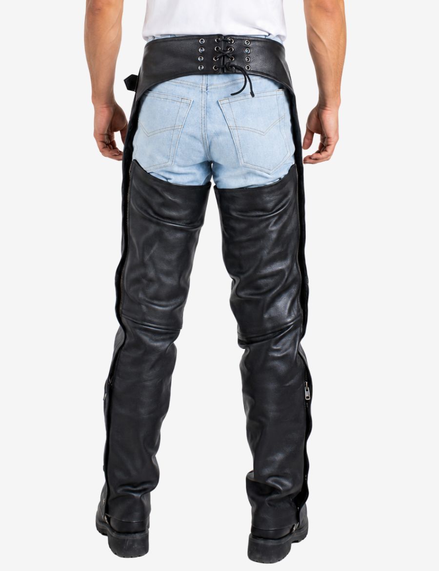 Back view of black cowhide leather chaps for men featuring lace-up waistband and rear zipper leg design.