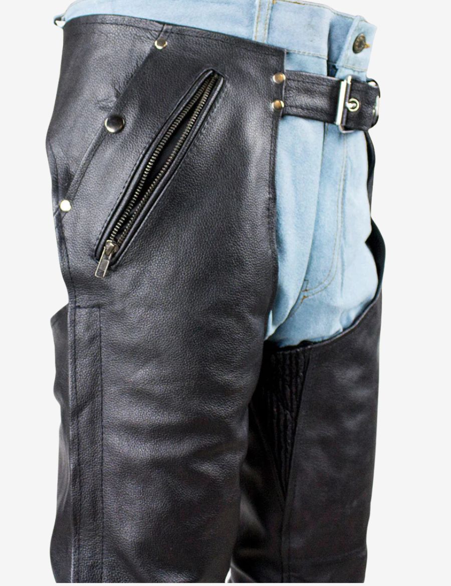 Close-up detail of rider fit cowhide leather chaps for men showing angled zipper pocket and premium black leather texture.