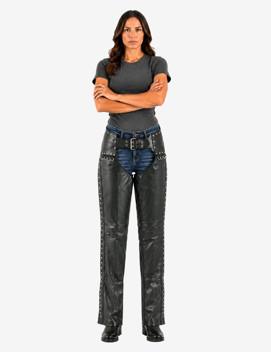 Front view of studded leather ladies motorcycle chaps worn by model featuring belt waist closure, decorative rivets, and full-length protective riding design.