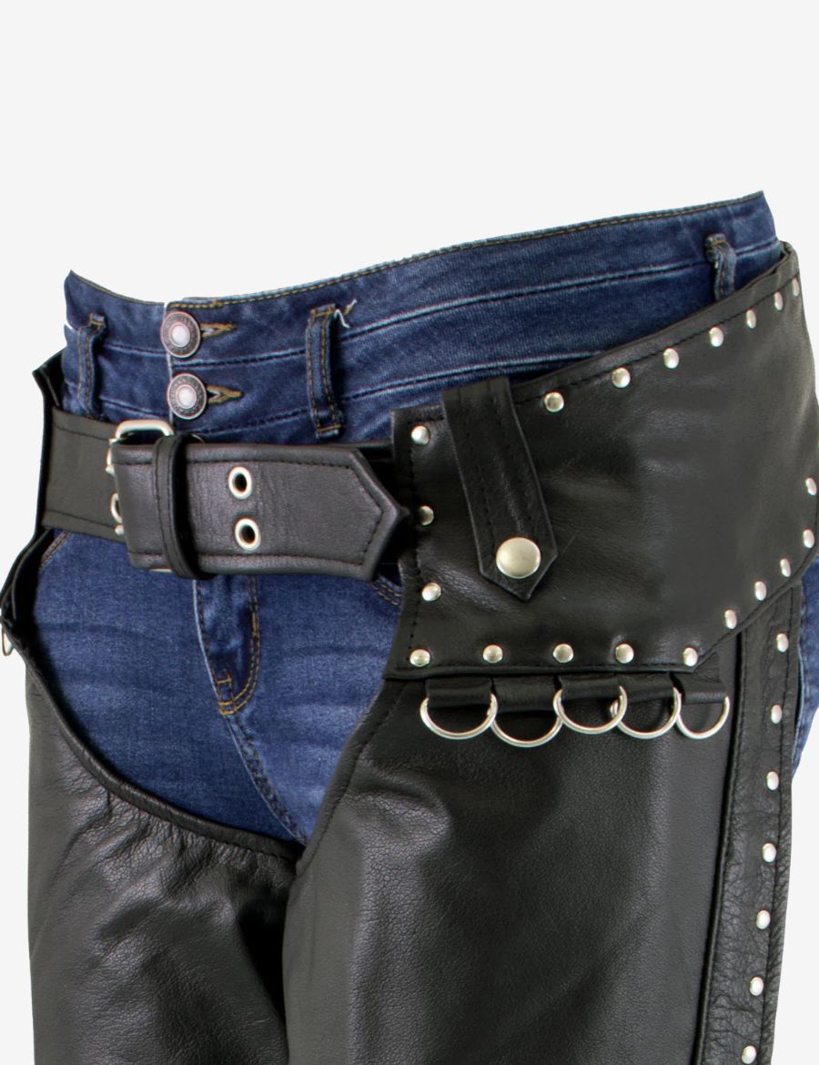 Close-up detail of studded leather motorcycle chaps waist area showing belt buckle, metal rivets, and premium leather craftsmanship.