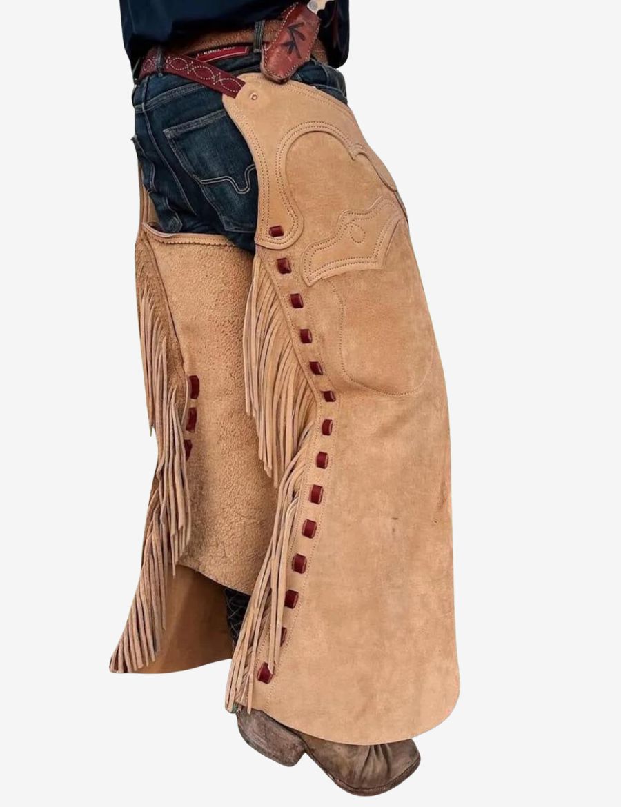 Angled view of tan batwing chaps featuring long fringe, suede leather, decorative accents, and cowboy riding design.