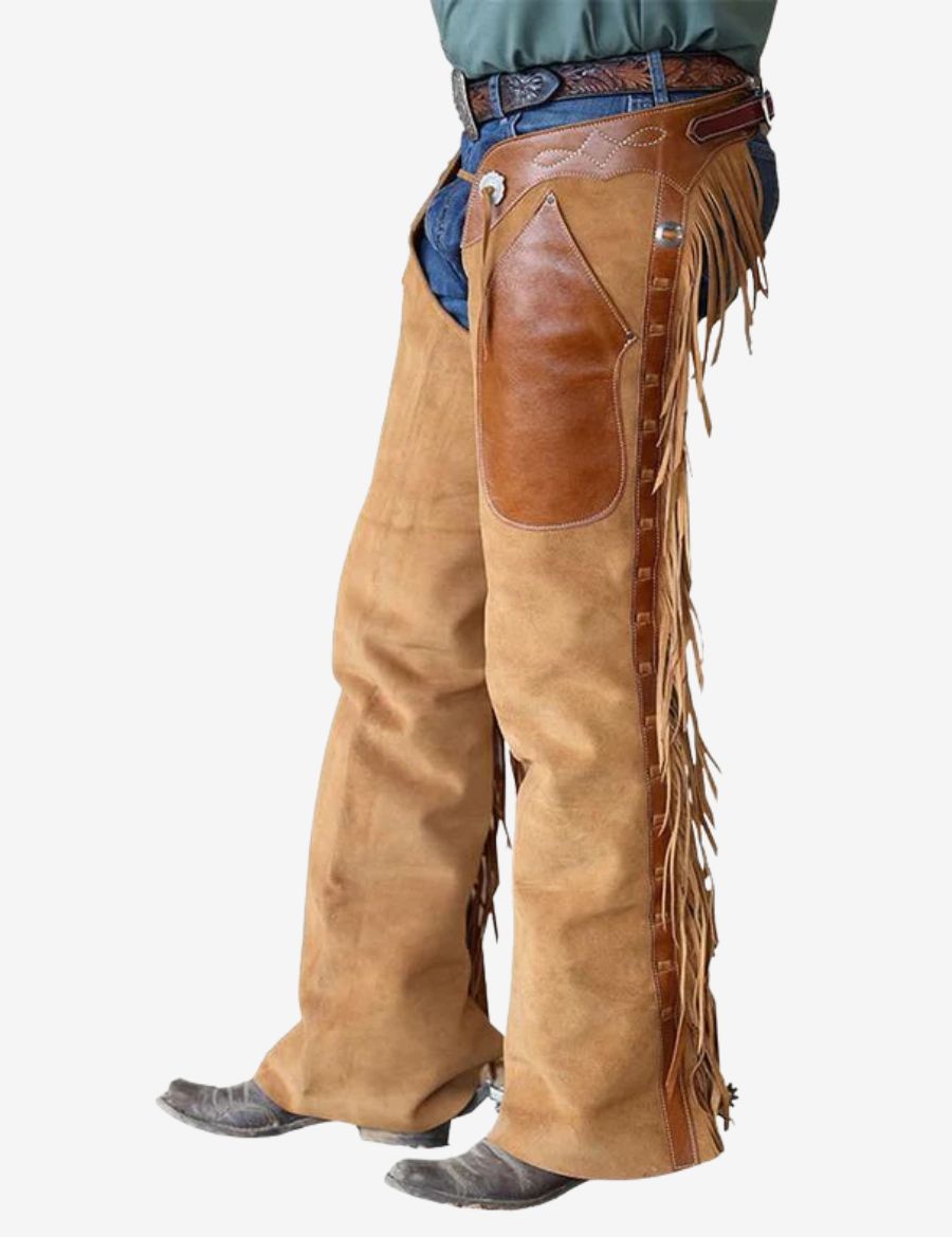 Front angled view of tan suede shotgun chaps with leather overlay panels, fringe trim, and western cowboy styling.