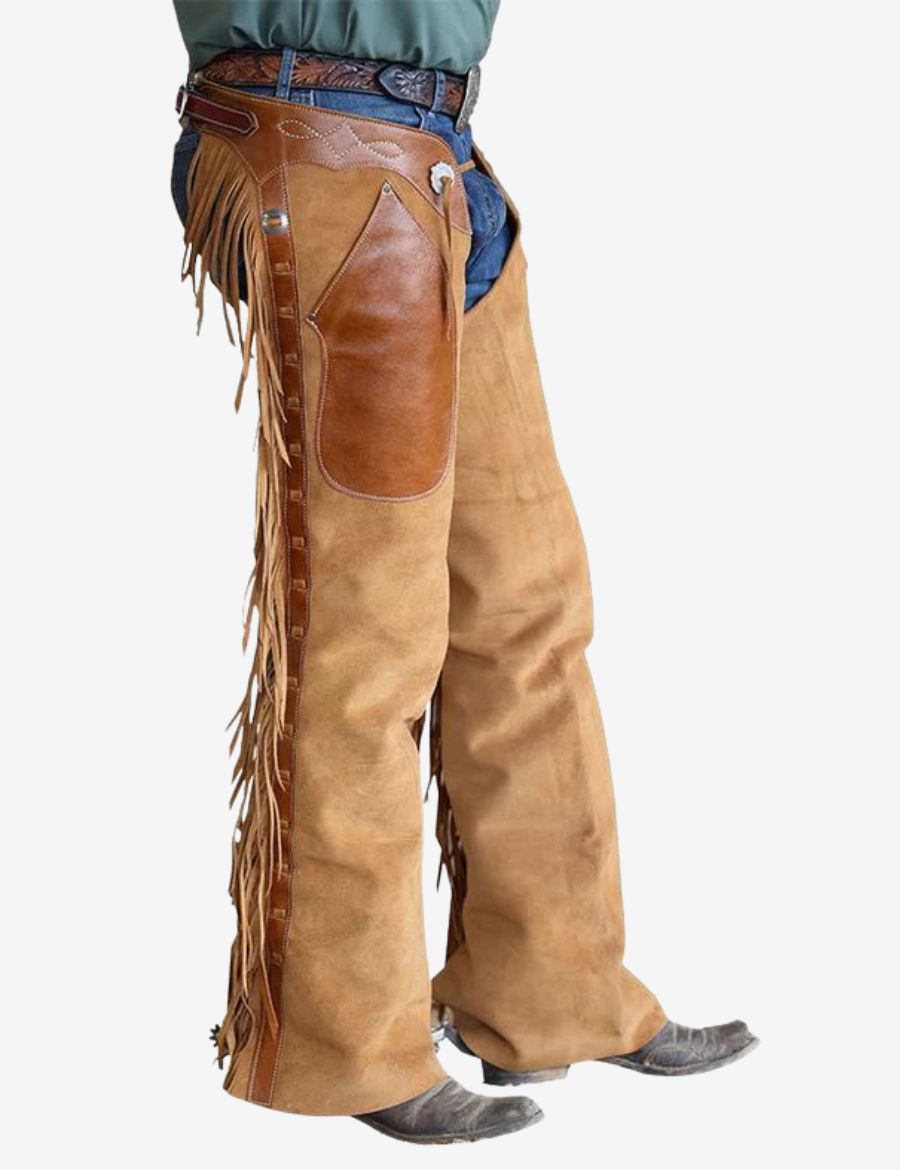 Side profile of tan suede shotgun chaps featuring long fringe accents, leather detailing, and classic rodeo design.