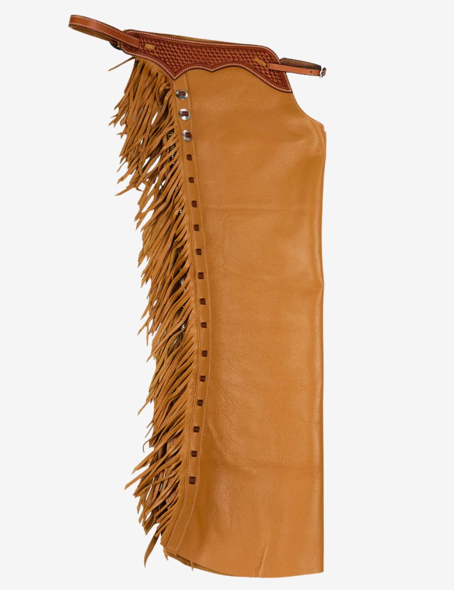 Rear side view of tooled leather cowboy shotgun chaps featuring braided top, flowing fringe, and western craftsmanship.