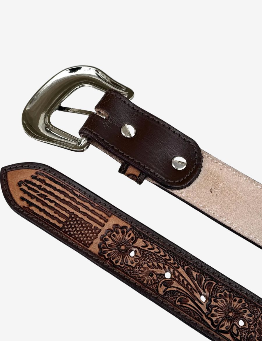 Close-up of a western leather belt showcasing American flag tooling, floral artwork, and premium leather craftsmanship.