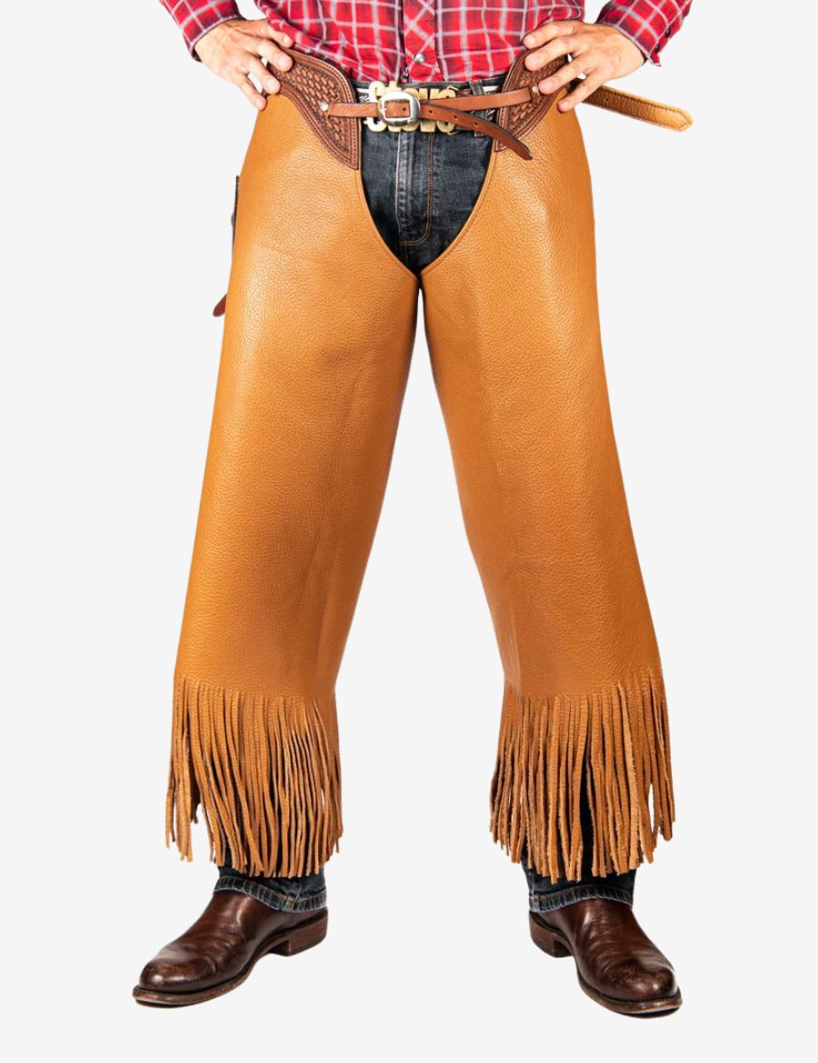 Buy western cognac cowhide chinks chaps featuring rugged leather texture, decorative tooling, and classic western fringe details.