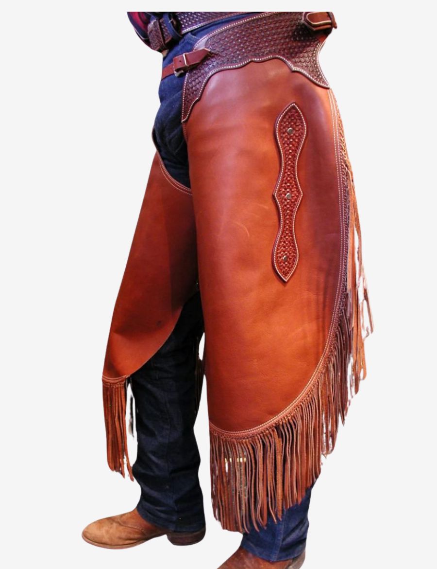 Buy western heritage trim chinks chaps featuring rich brown leather, western tooling details, and flowing fringe for ranch and cowboy wear.