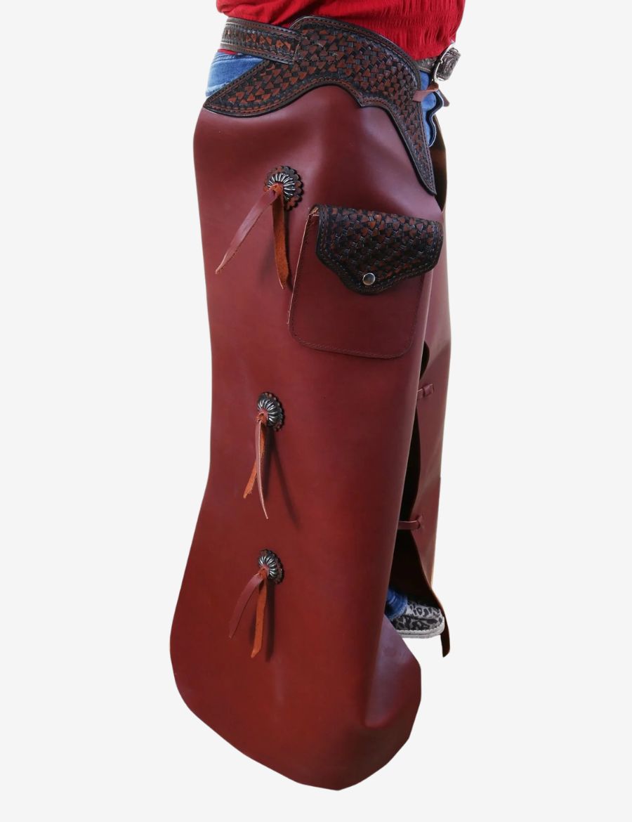 Side view of western leather batwing chaps featuring basketweave tooling, utility pocket, and concho details.
